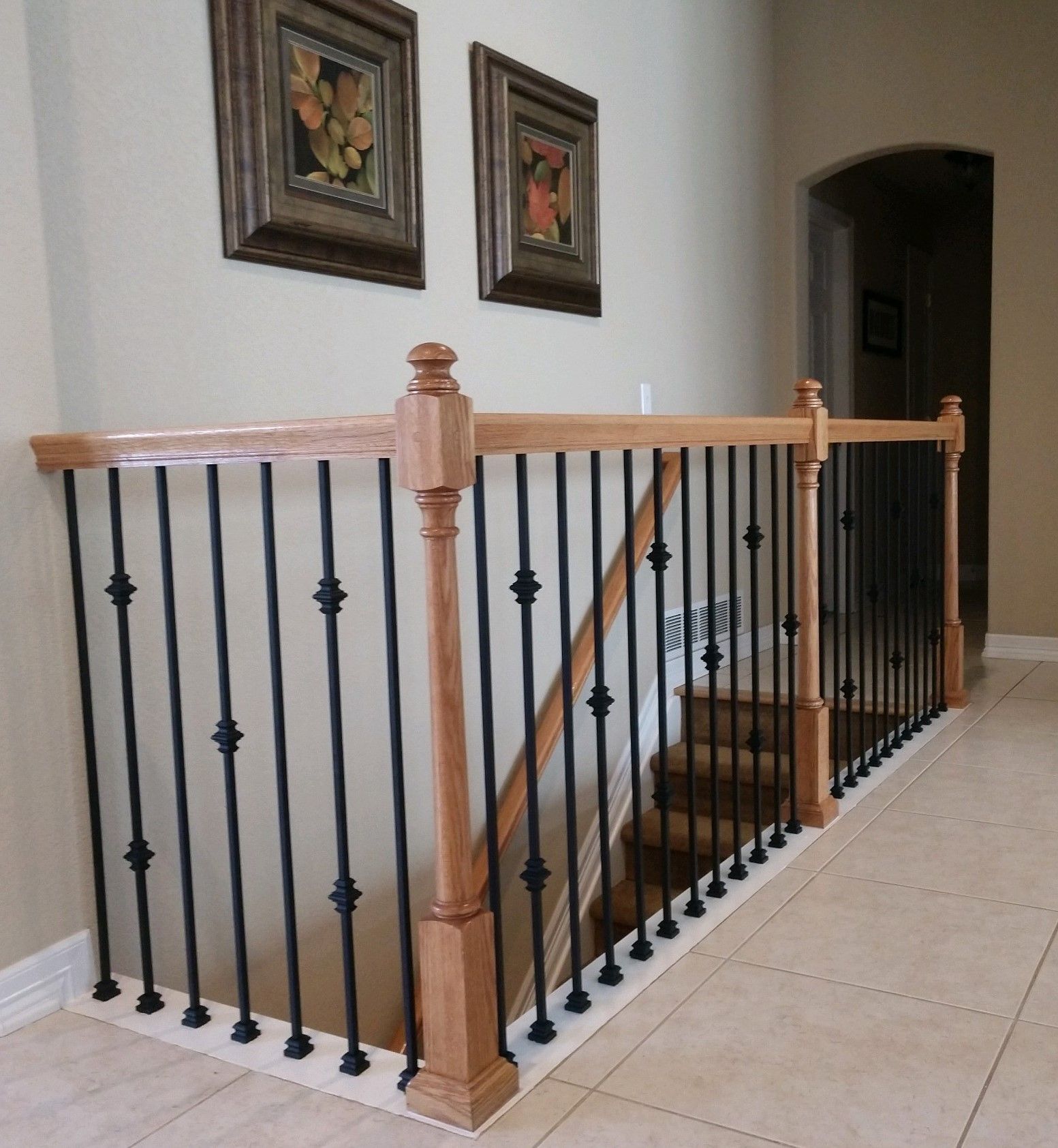 A staircase with a wooden railing and a metal railing