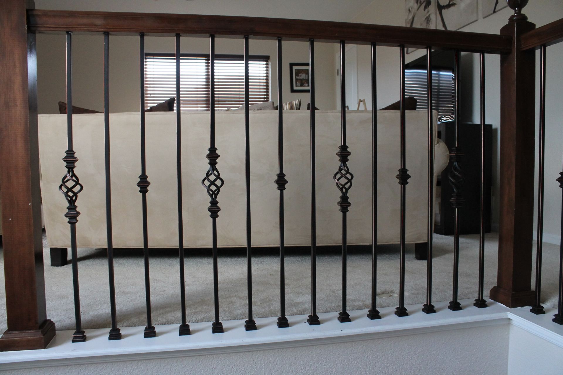 A staircase with a wrought iron railing in a living room