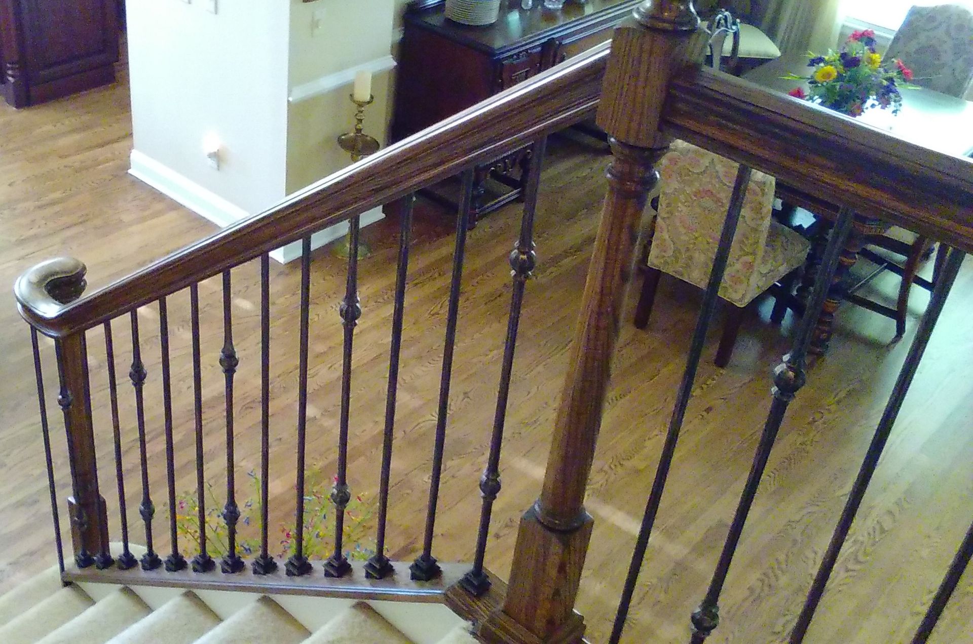 A wooden staircase with a metal railing in a living room