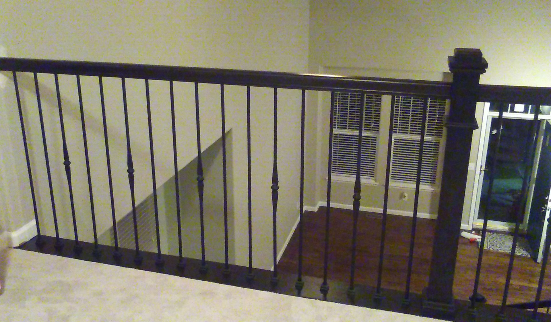A staircase with a wrought iron railing in a house