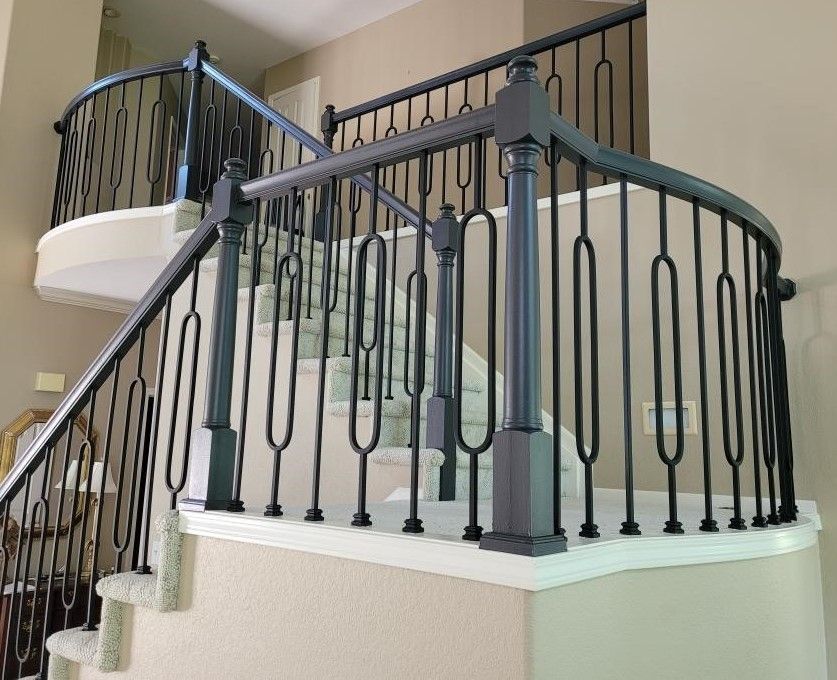 A staircase with a black railing in a house.