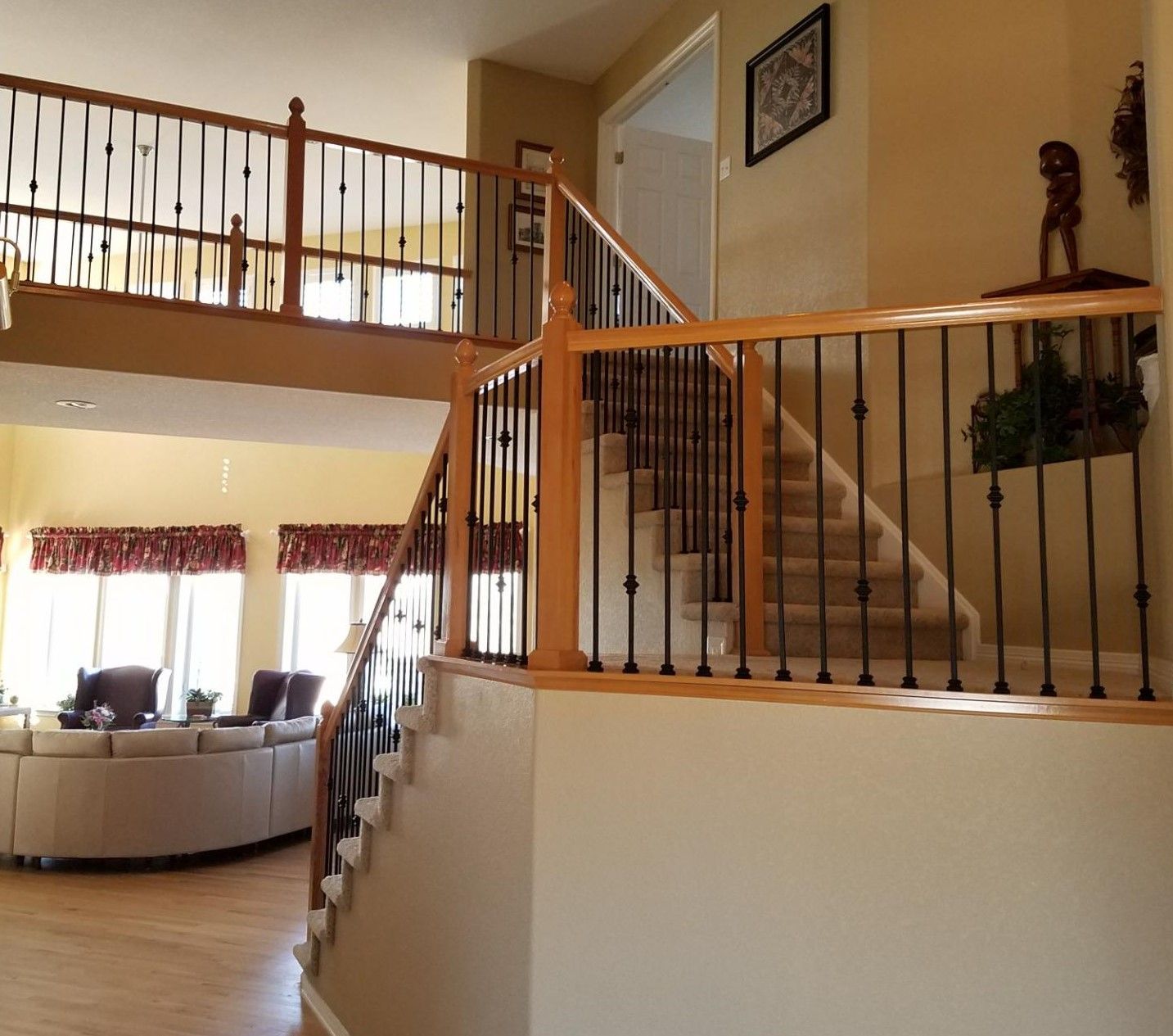 A living room with stairs leading up to the second floor