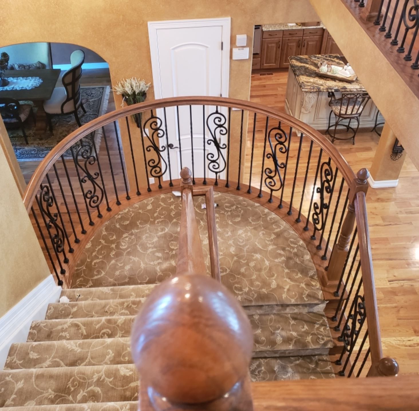 An aerial view of a staircase with a wrought iron railing