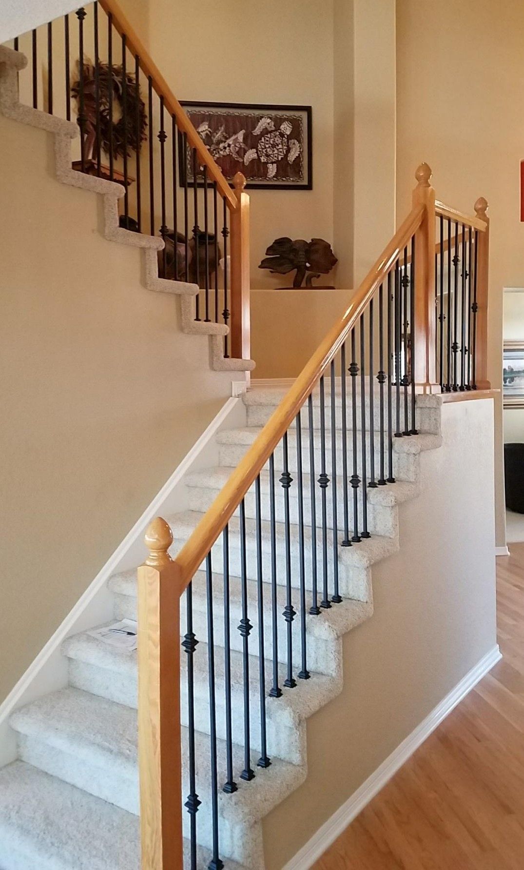 A staircase with a wooden railing and carpeted steps in a house.