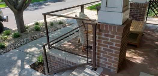 A brick building with a metal railing on the side of it.