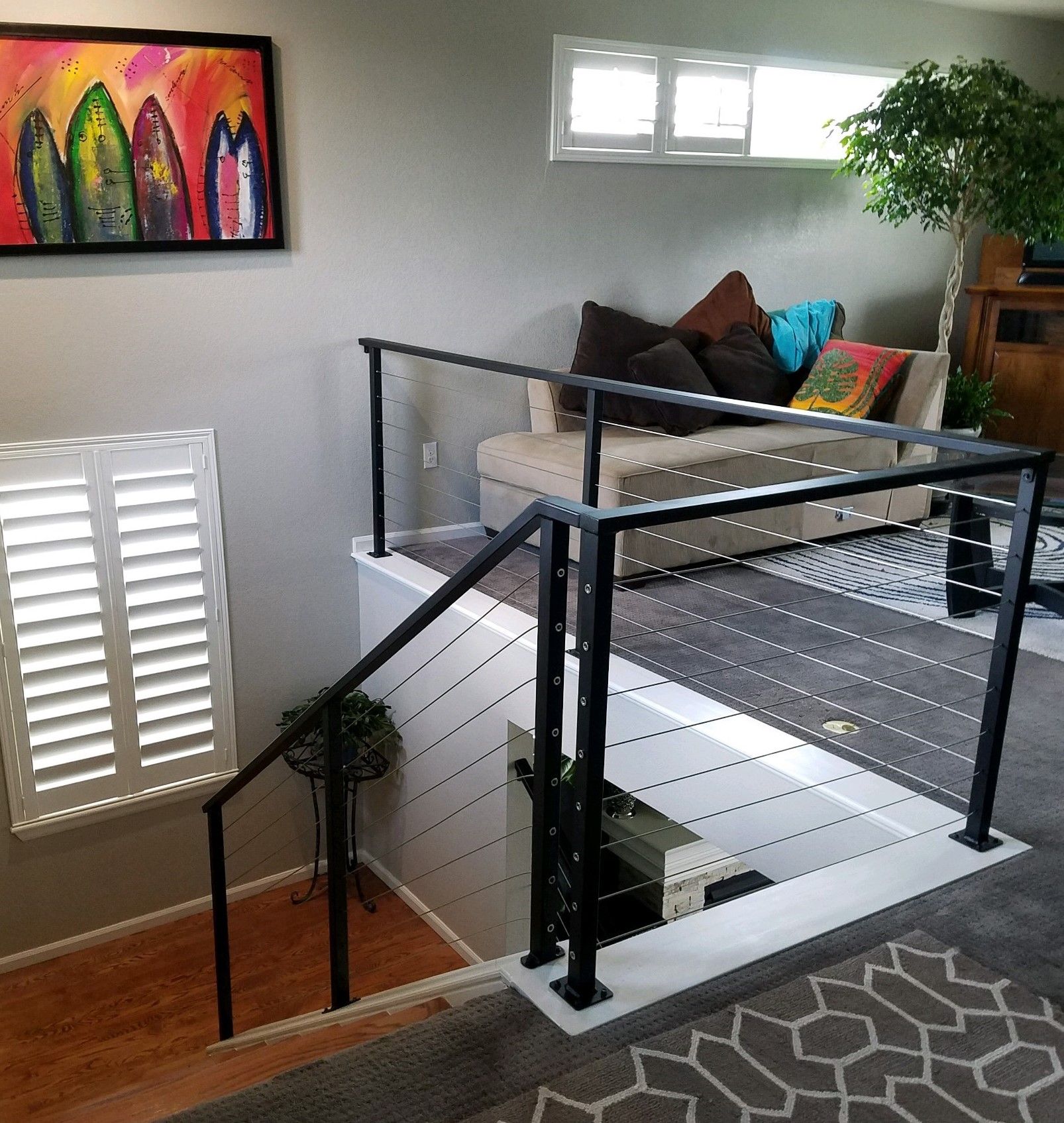 A living room with a couch and a picture on the wall