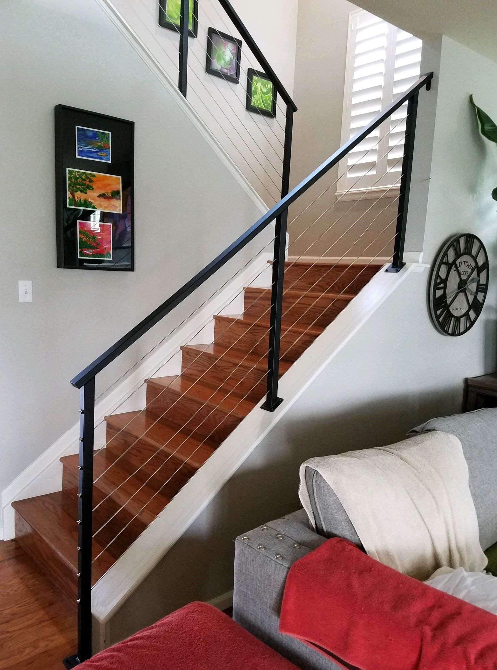 A living room with stairs leading up to the second floor
