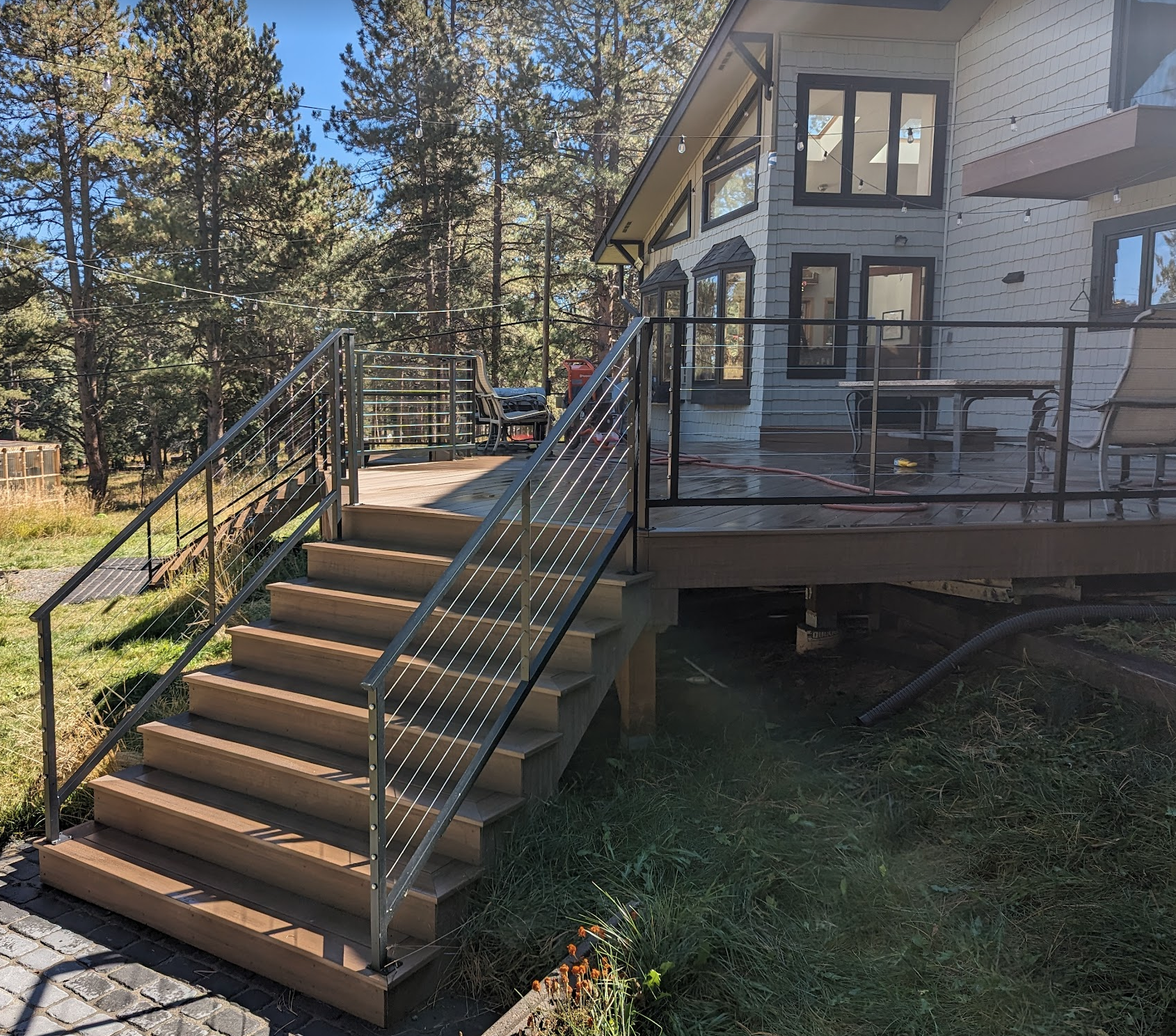 A house with a deck and stairs leading up to it