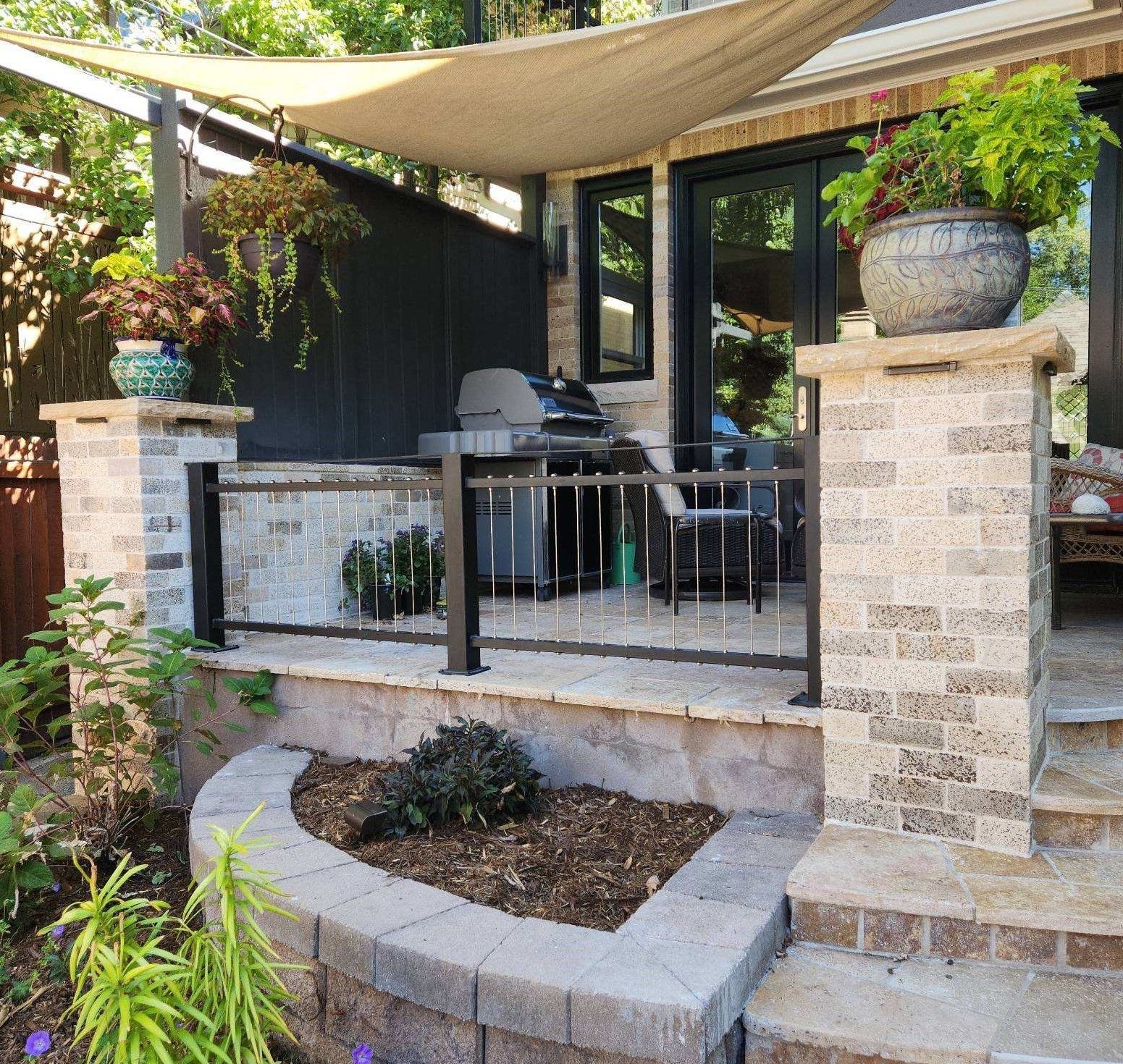 A patio with a grill and a canopy over it