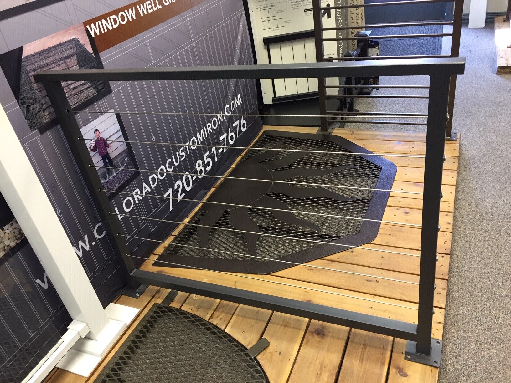 A metal railing is sitting on a wooden floor in a room.