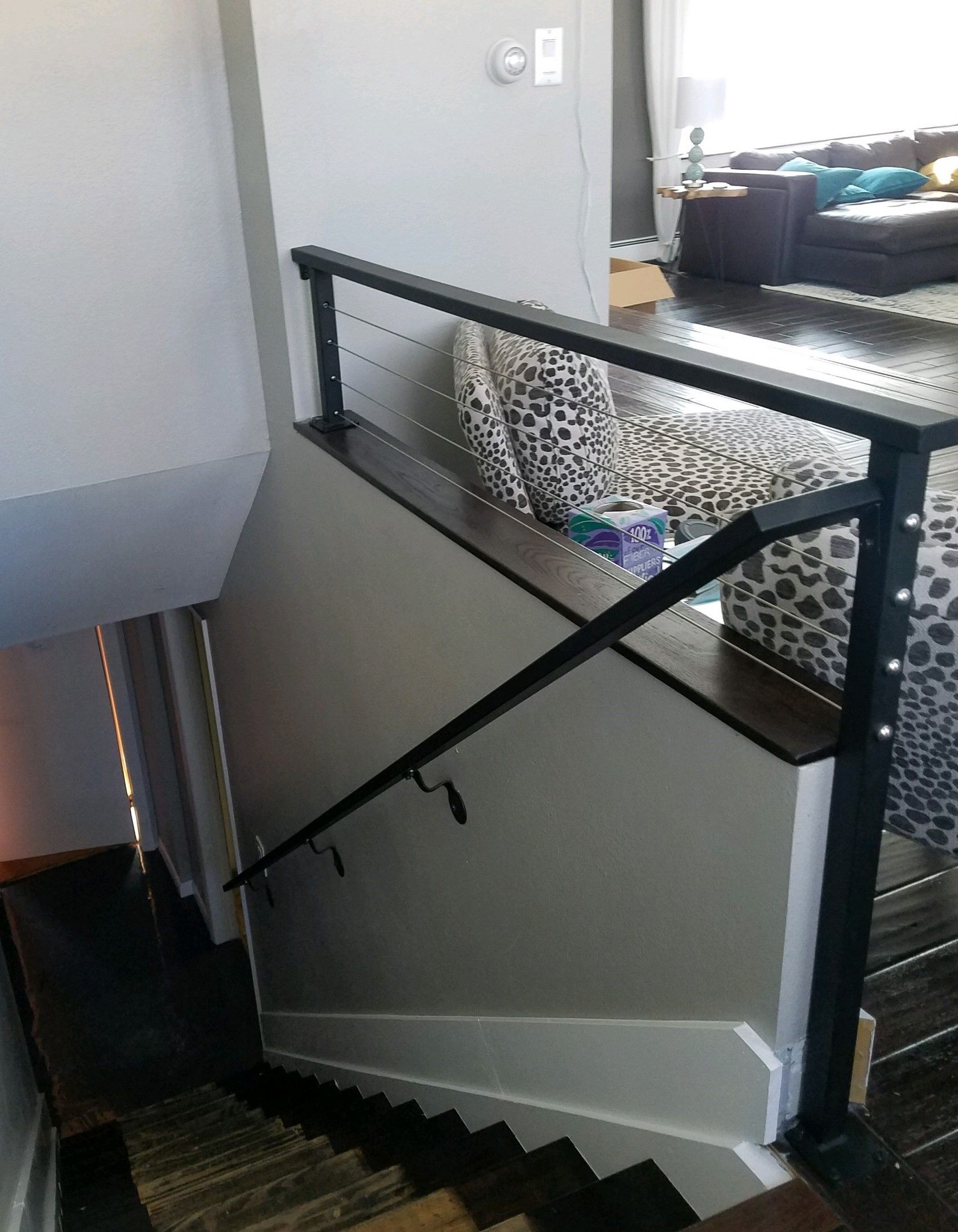 A staircase leading up to a living room with a couch.