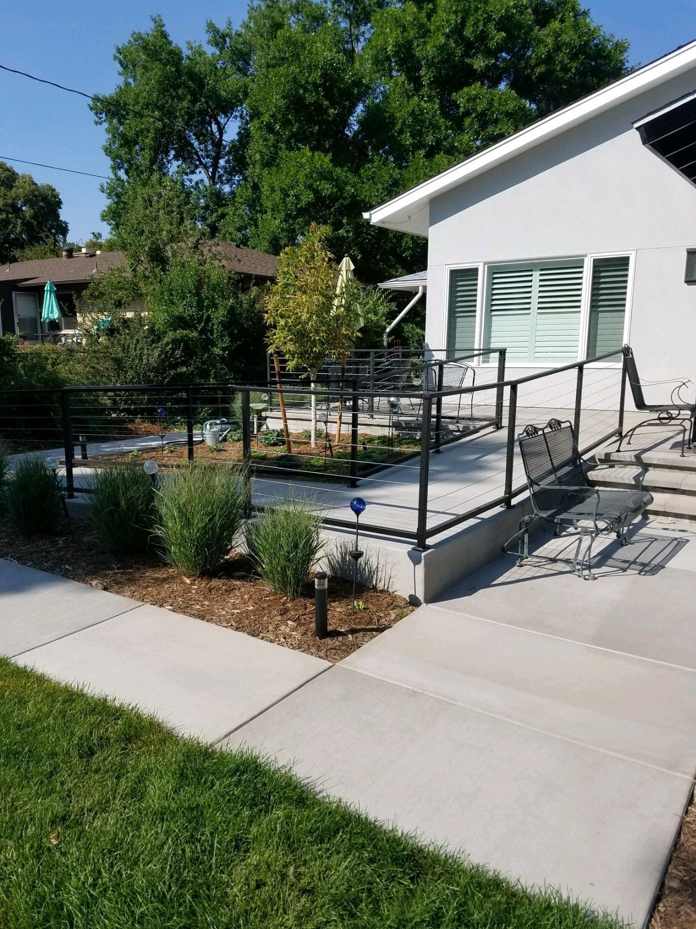 A house with a patio and stairs in front of it.