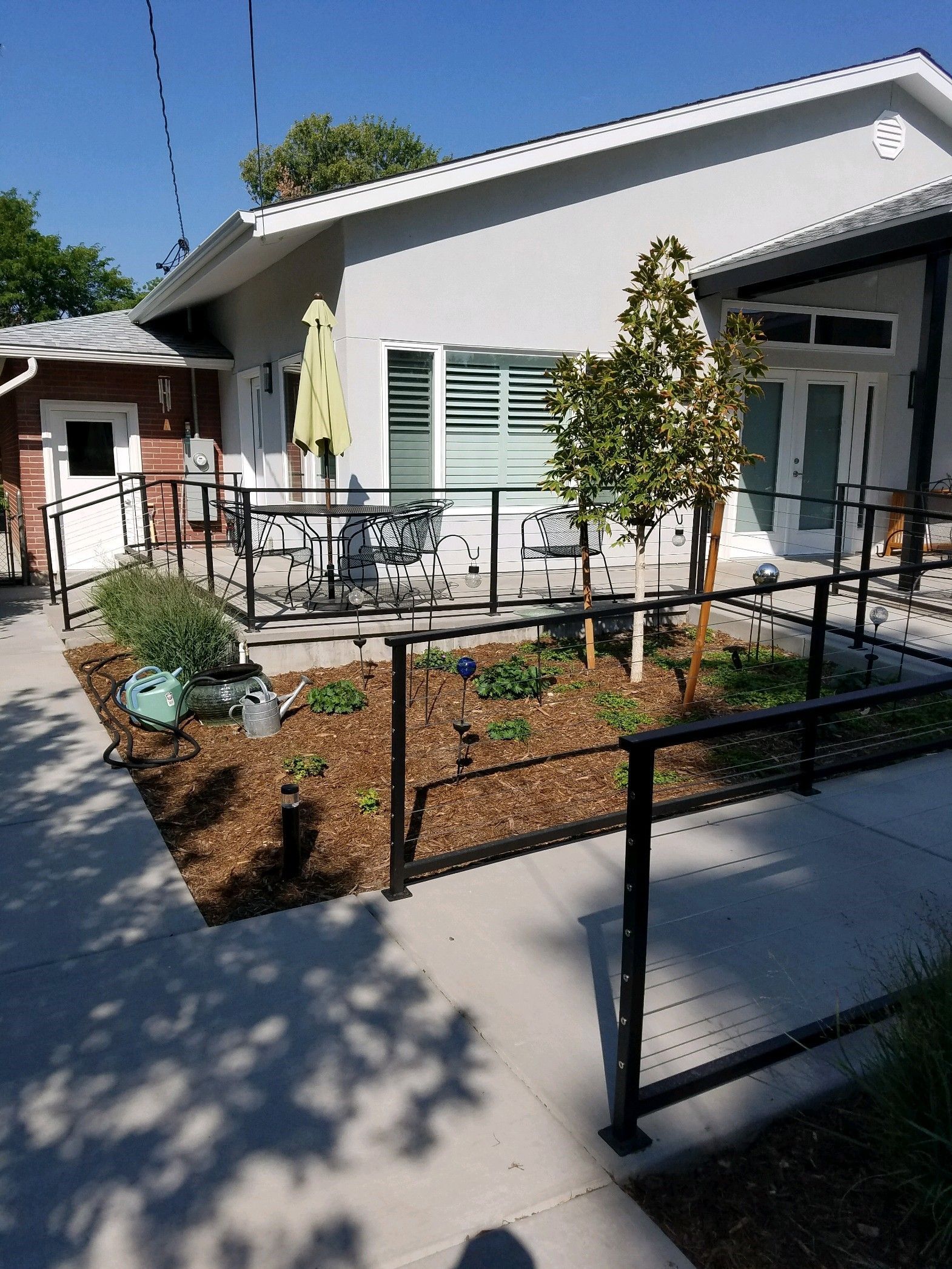 A house with a walkway leading to it and a fence around it