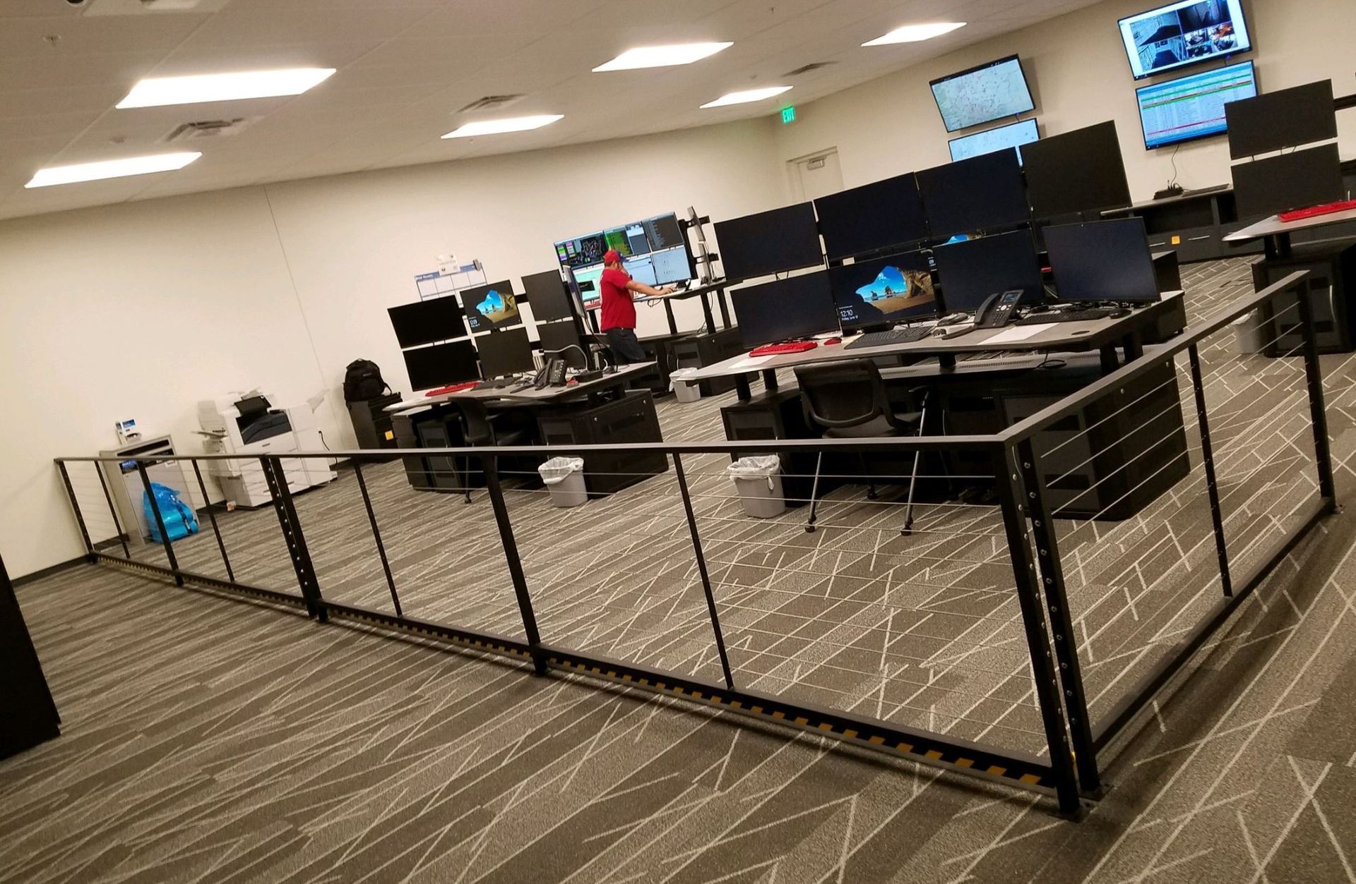 A large room filled with lots of computers and desks.