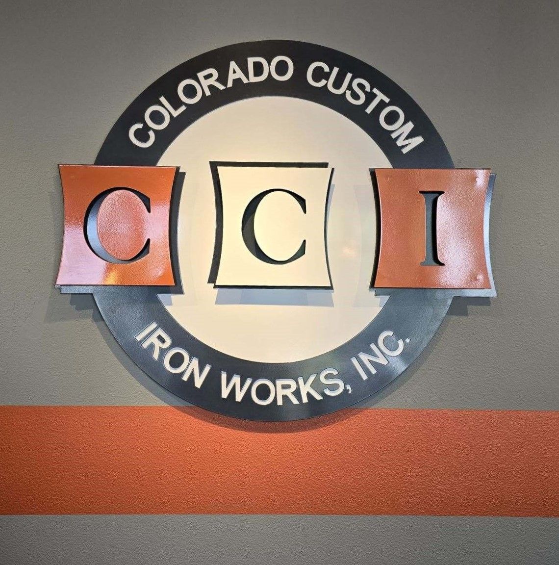 A logo for colorado custom iron works inc.