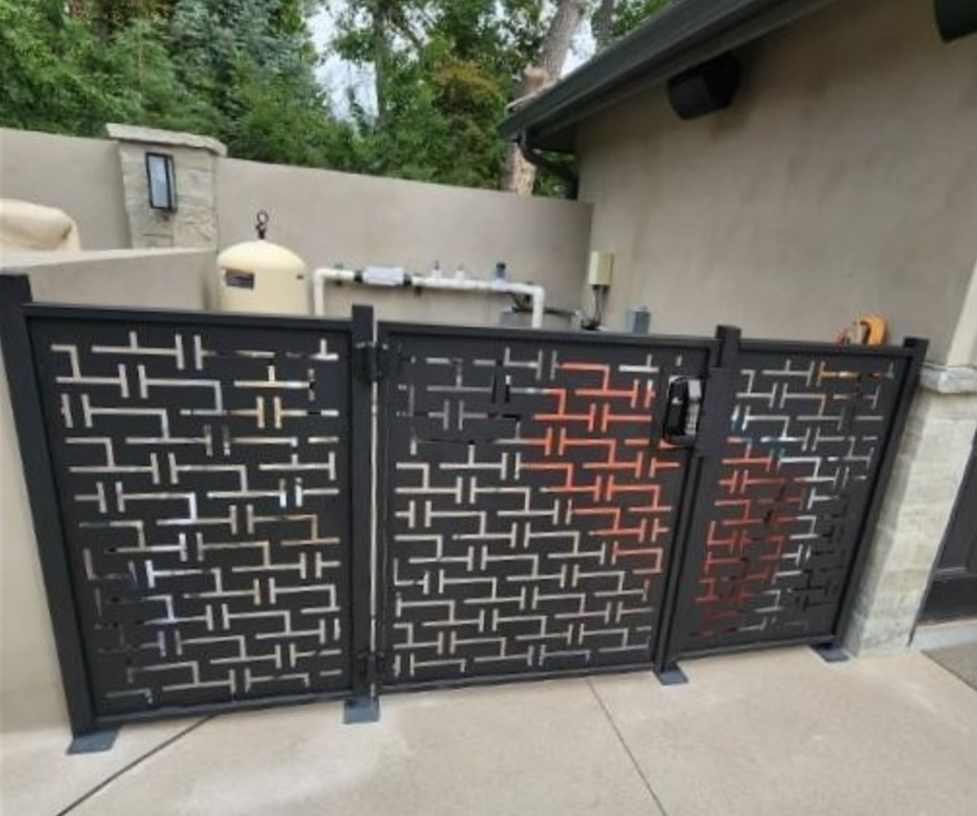 A black gate with a geometric pattern on it