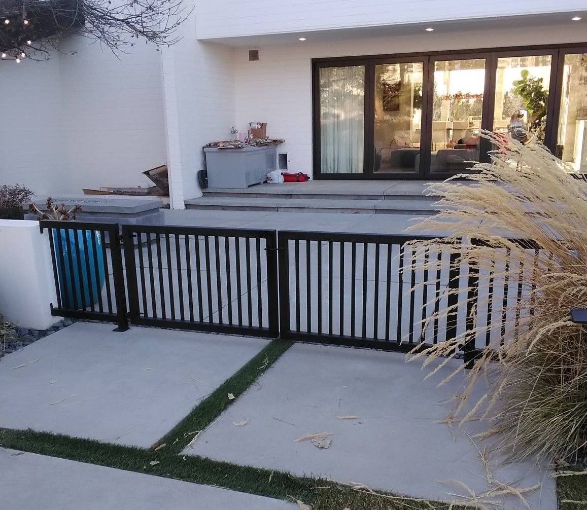 A white house with a black fence in front of it