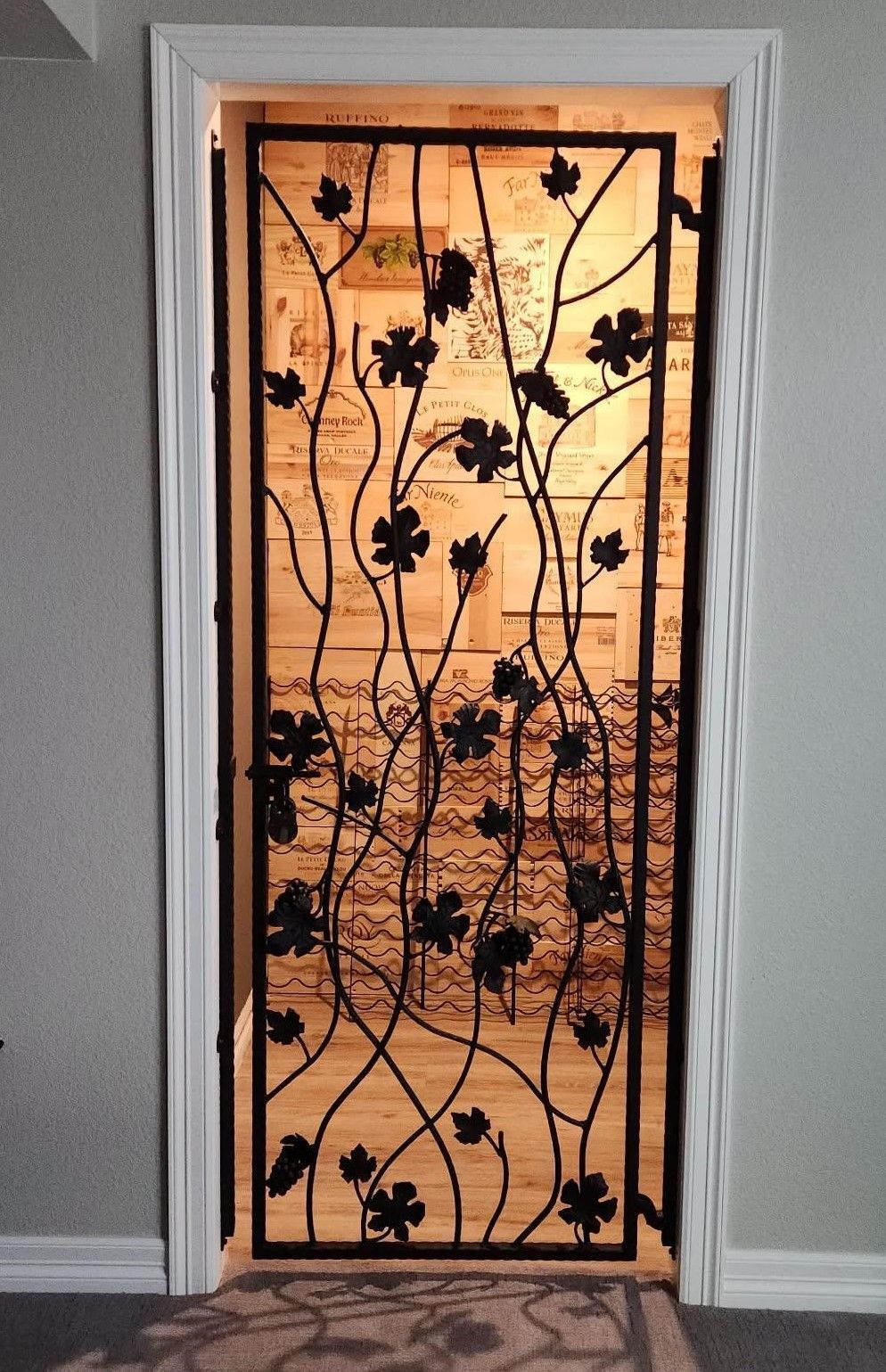 A wrought iron door with leaves on it
