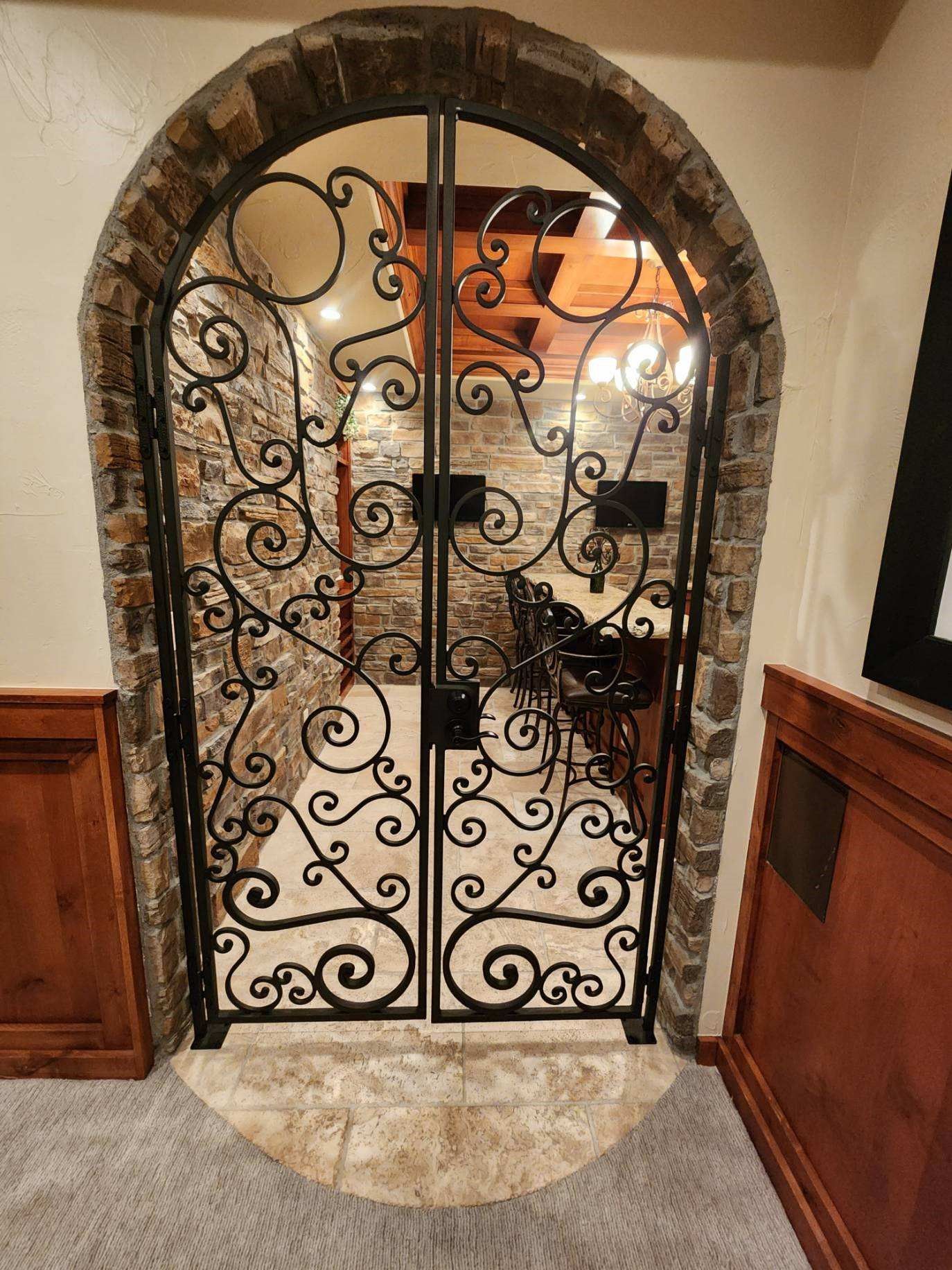 There is a wrought iron gate in the middle of a room.