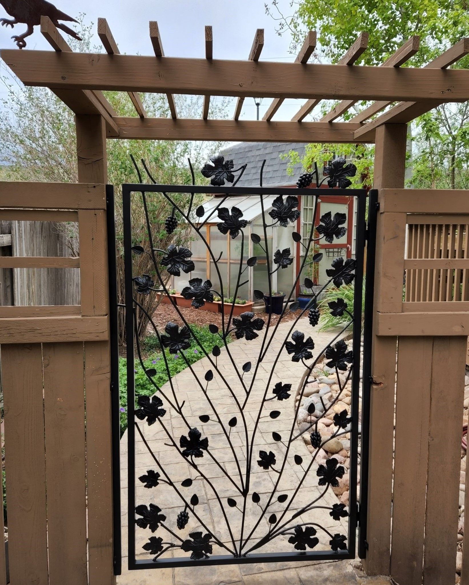A wrought iron gate with flowers on it