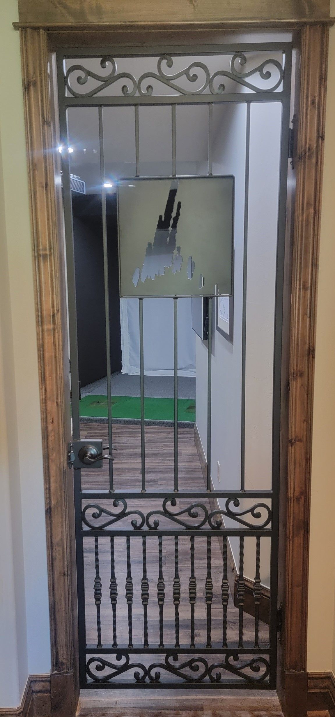 A door with a wrought iron gate in a room.
