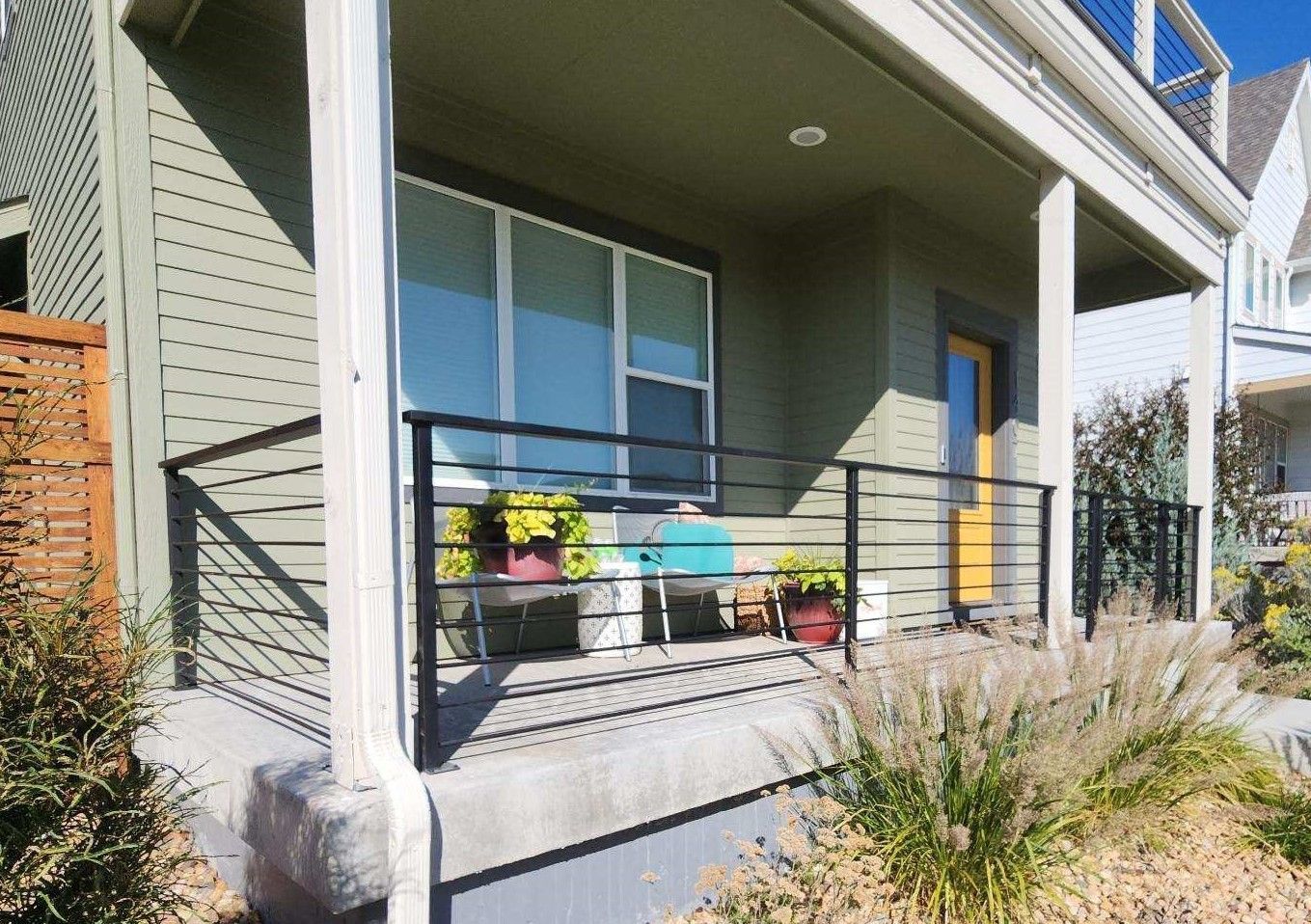 A porch of a house with a metal railing