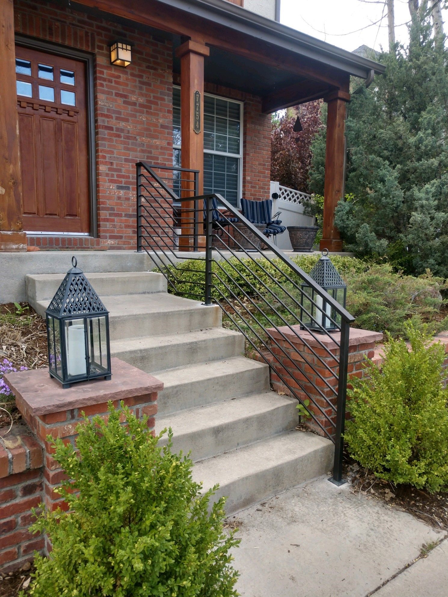 There is a lantern on the steps of a house.