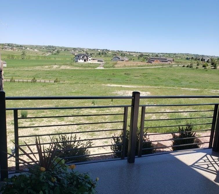 A view of a grassy field from a balcony