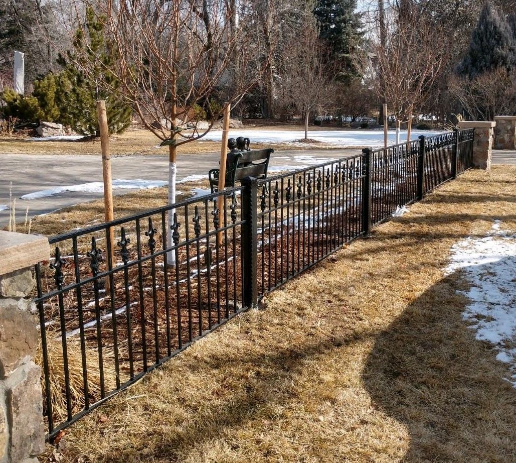 A stone wall with stairs and a lantern in front of it