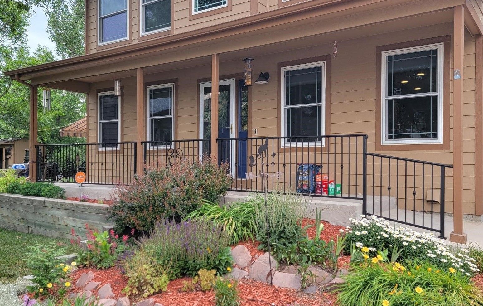 A house with a large porch and a wrought iron railing.