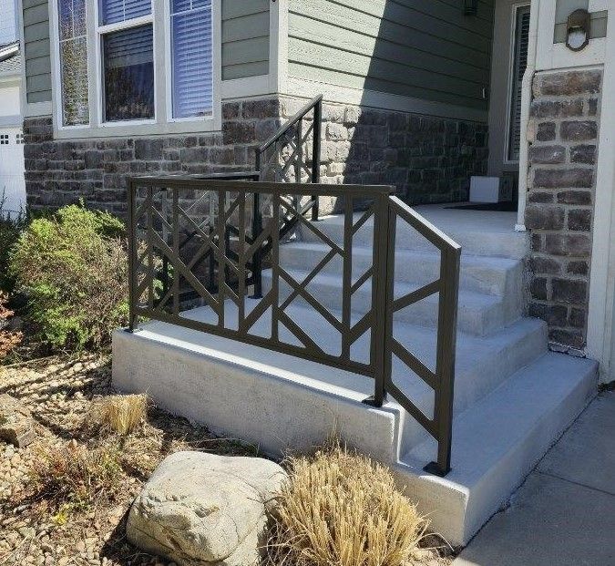A brick house with stairs and a metal railing