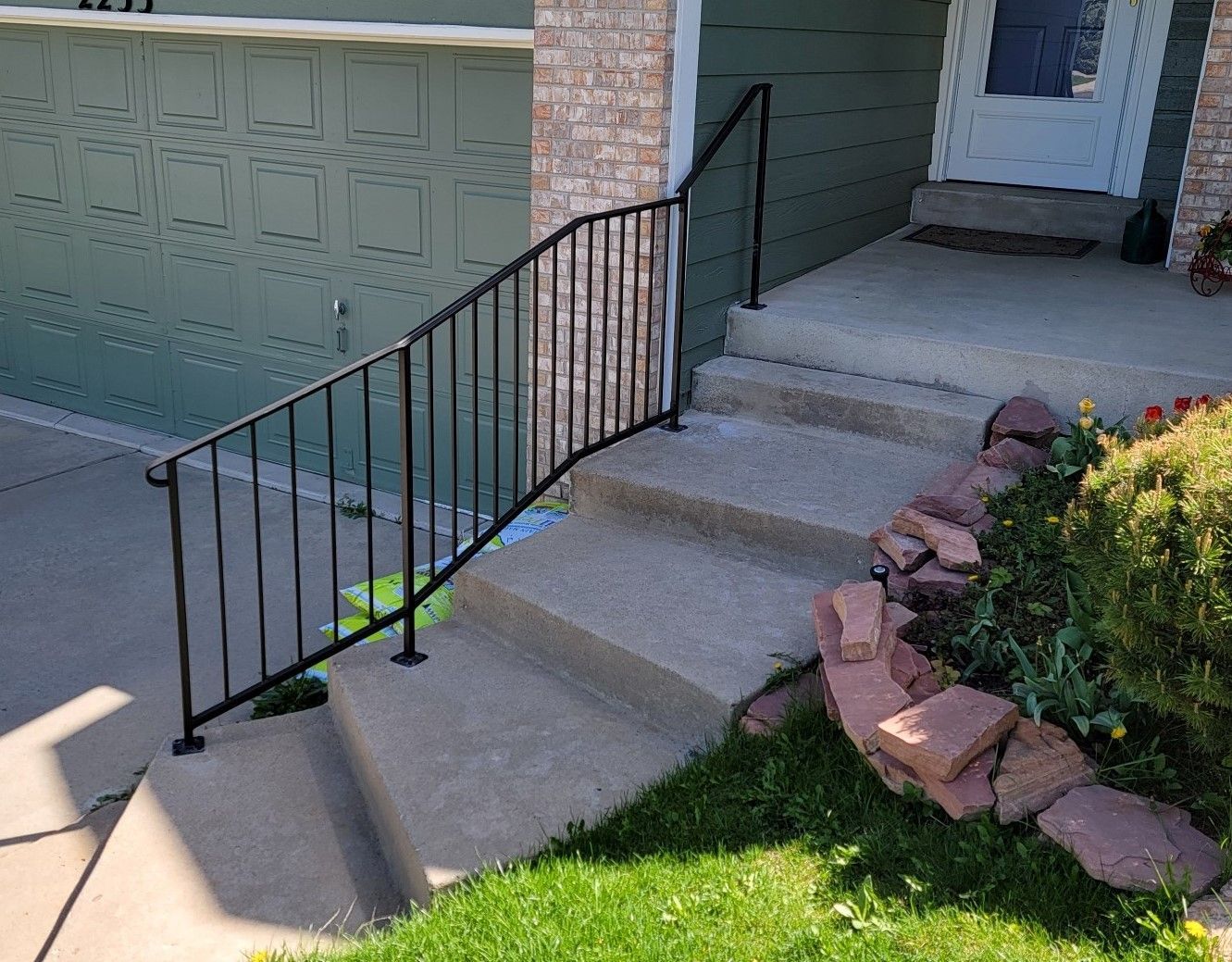 There is a wrought iron railing on the steps of a house.