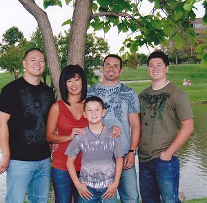 A group of people posing for a picture in front of a tree