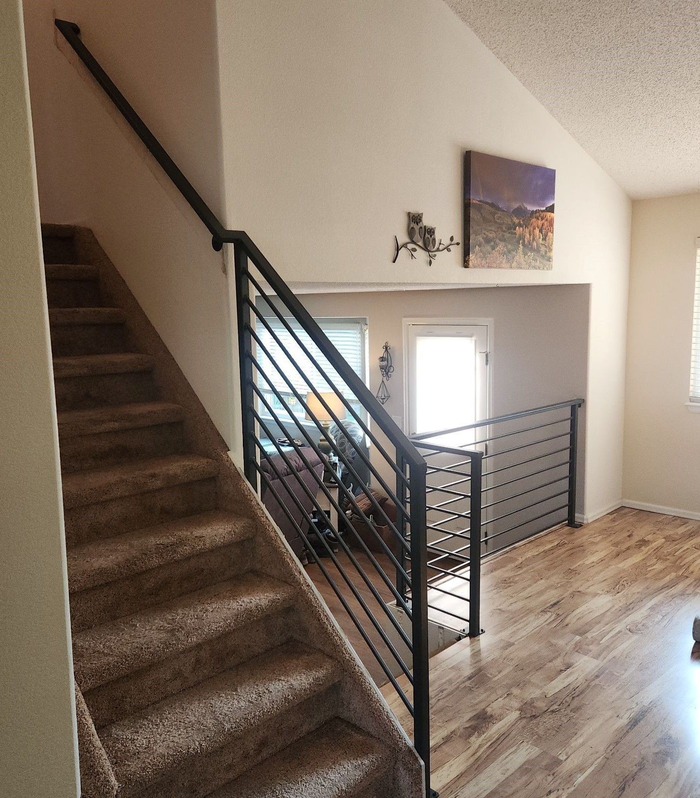 A staircase in a house with a black railing