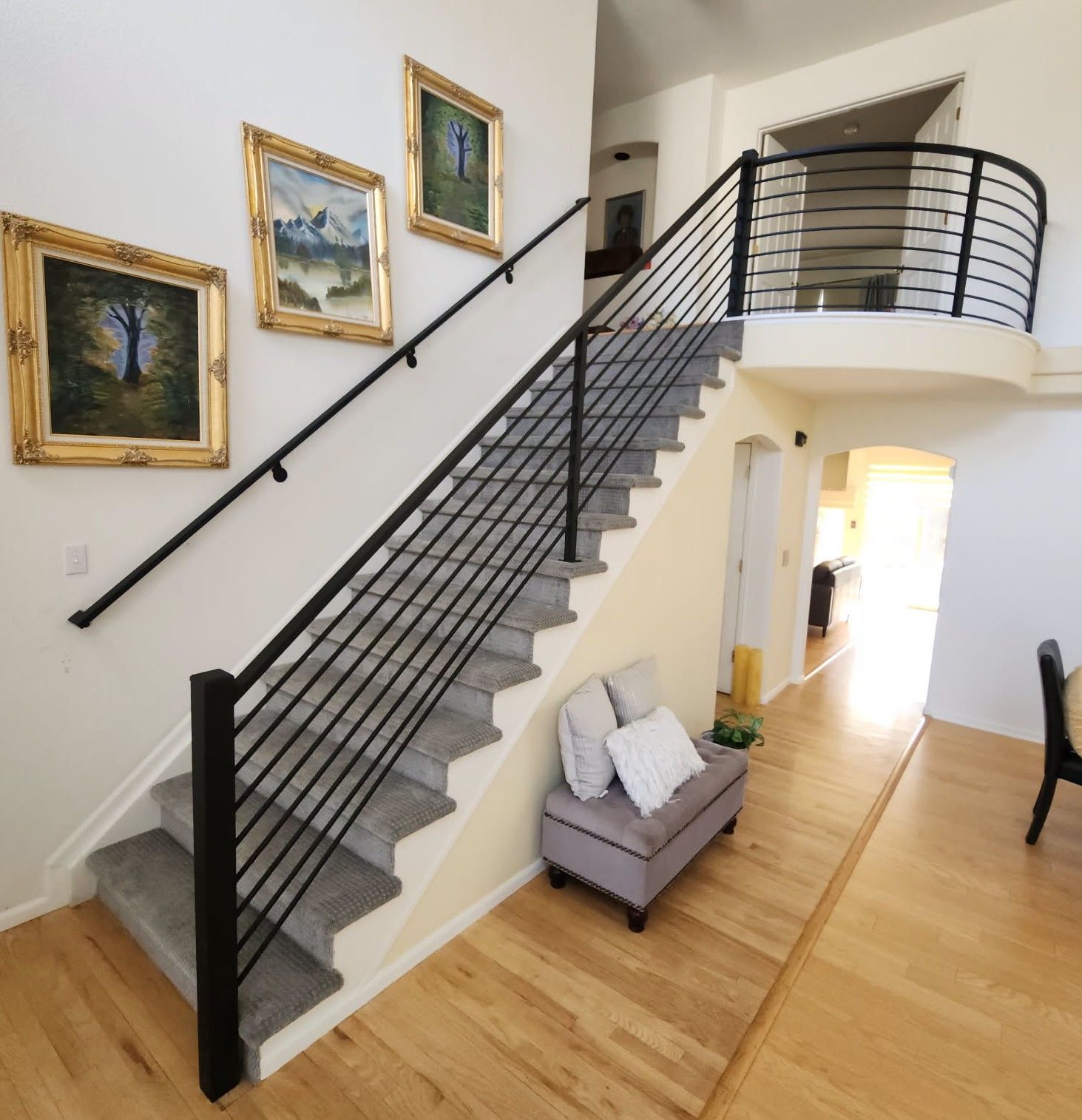 A staircase leading up to a balcony in a house