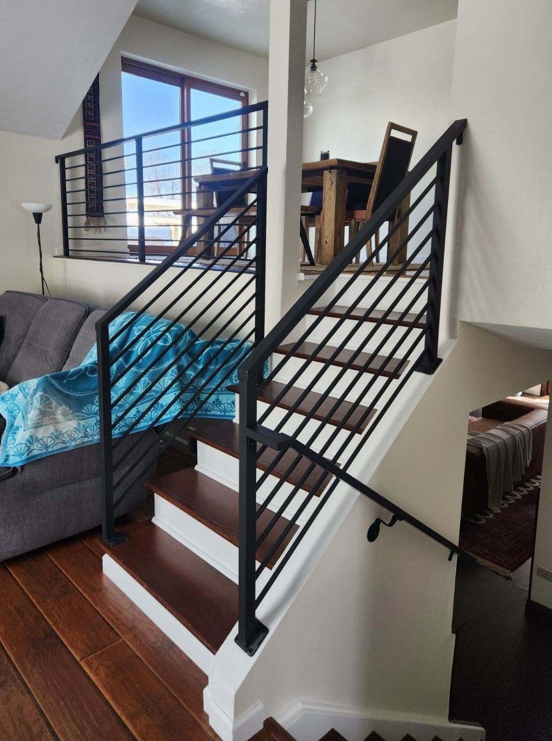 A living room with stairs leading up to the second floor