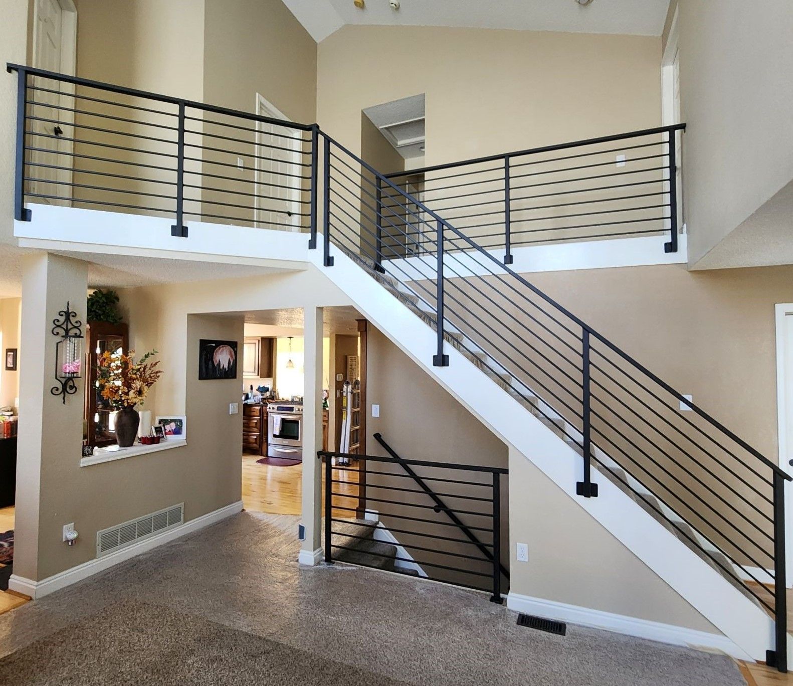 A staircase in a house with a black railing