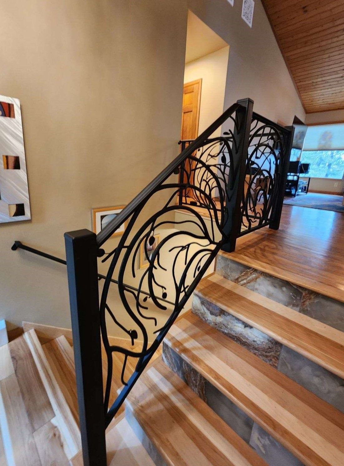 A staircase with a wrought iron railing in a house