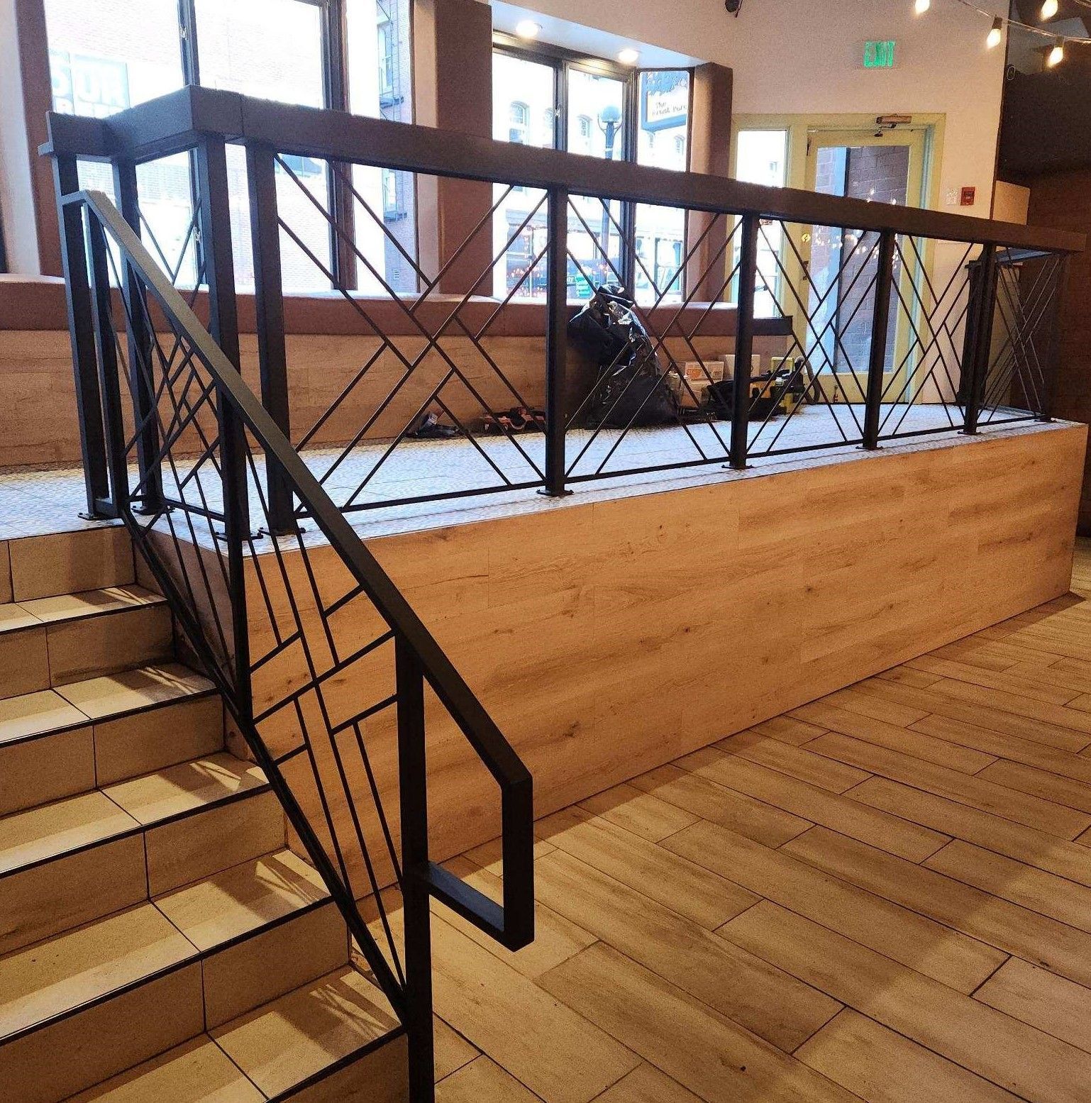 A staircase with a metal railing and wooden steps