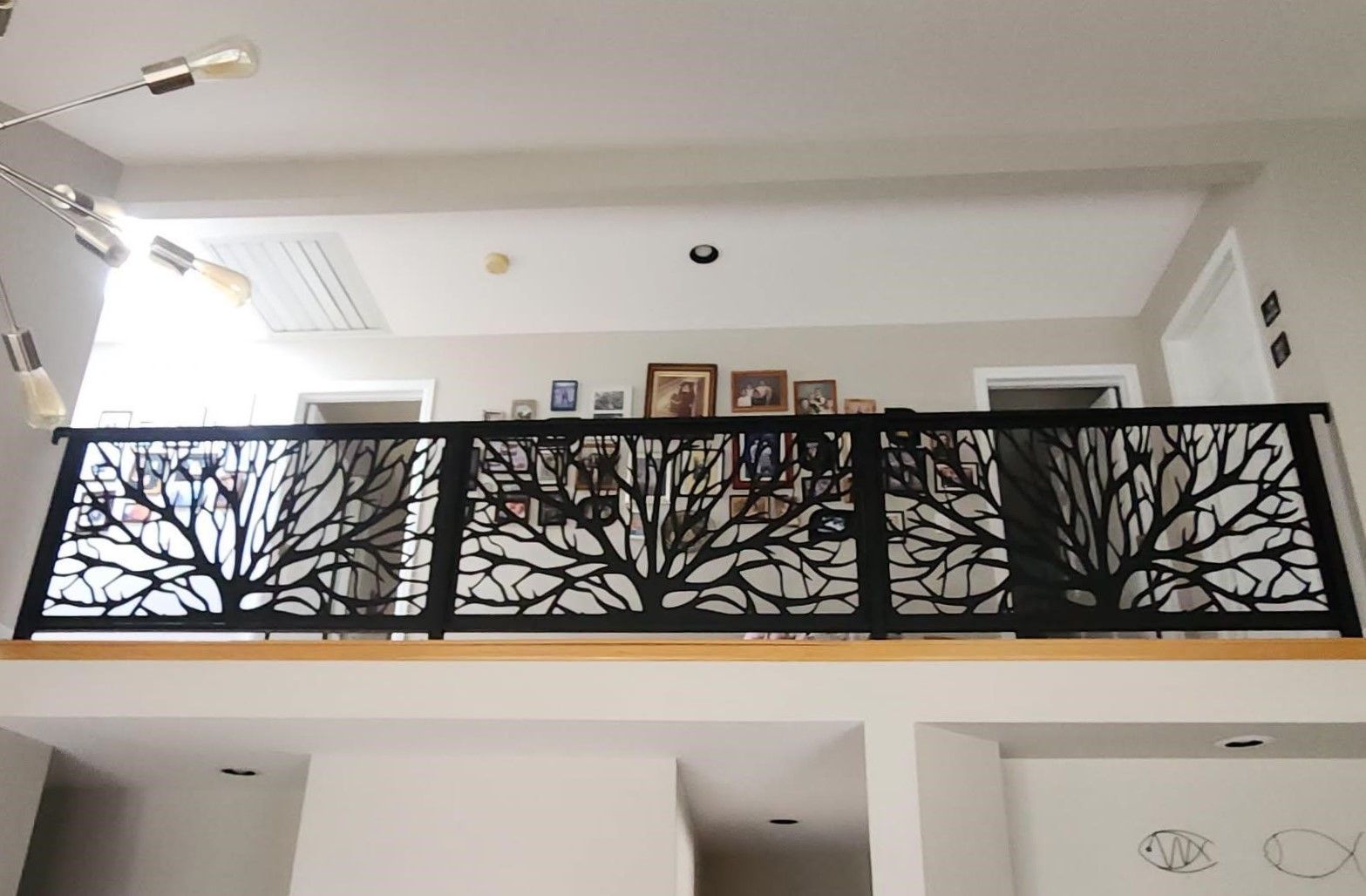 A balcony with a tree design on it in a house.