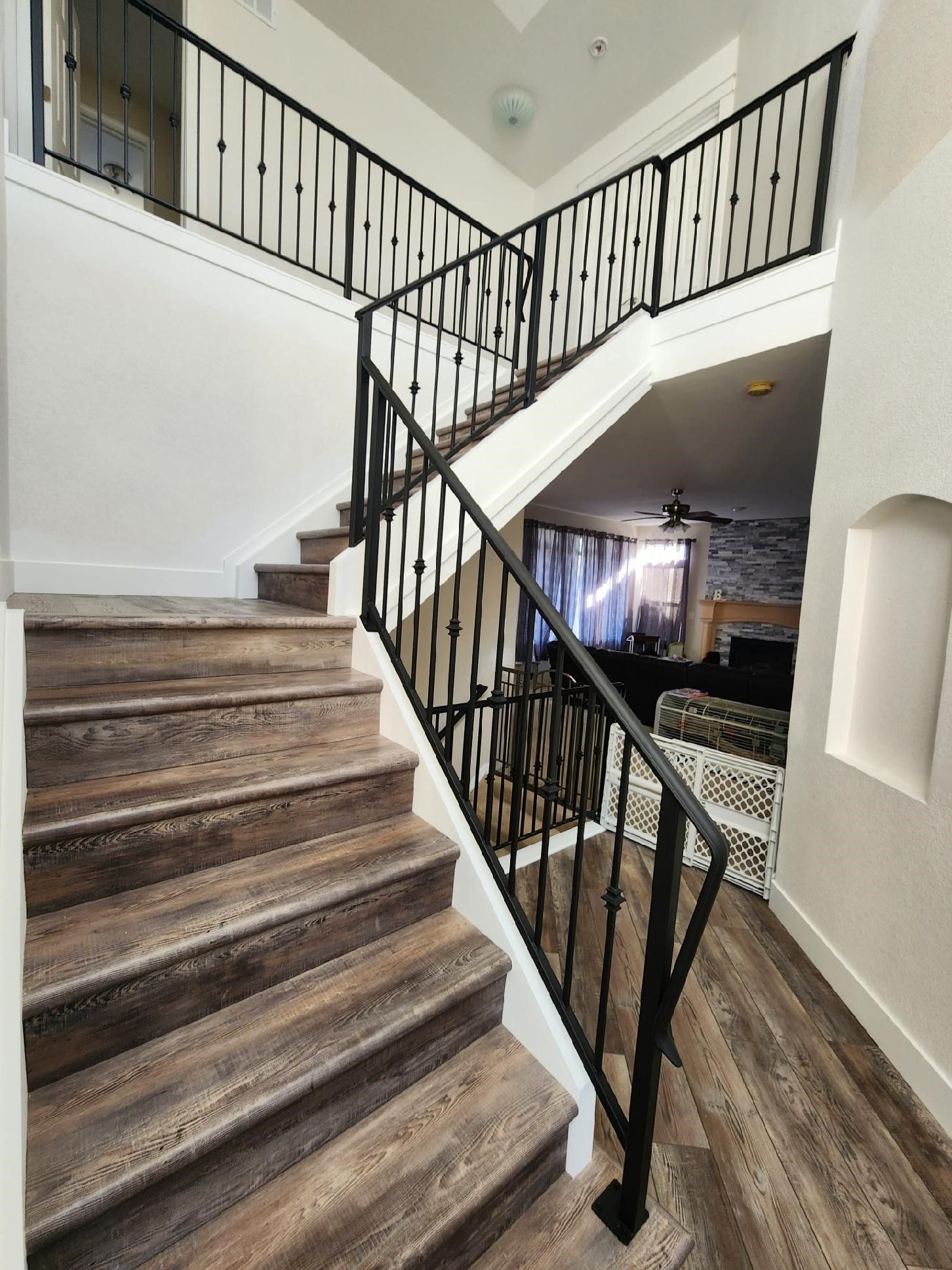 A wooden staircase with a metal railing in a house