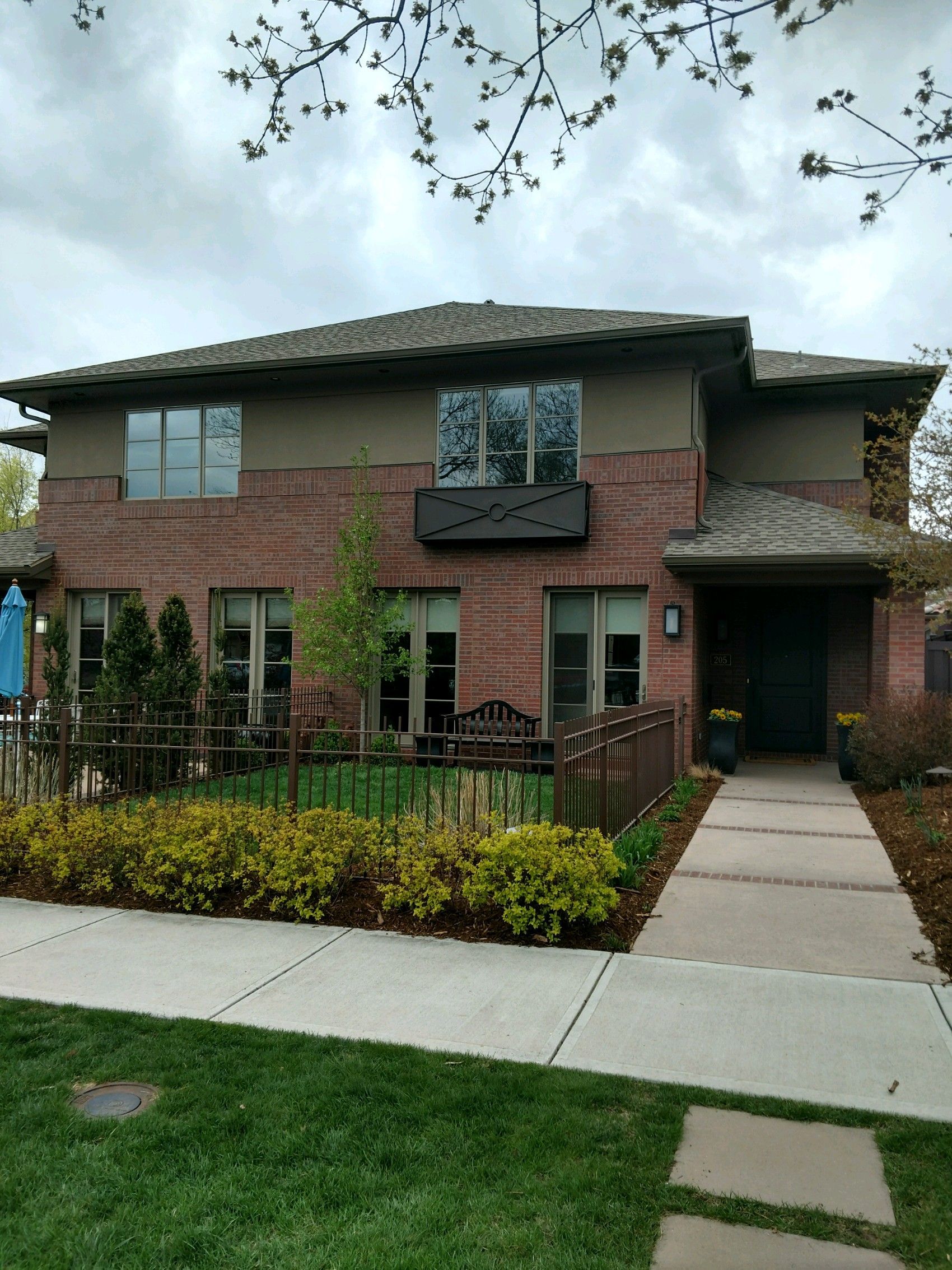A large brick house with a walkway leading to it