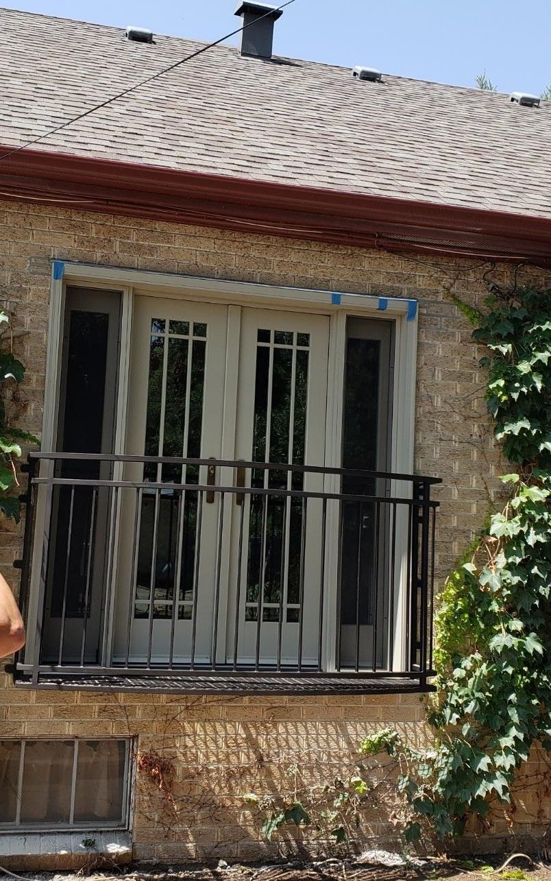 A house with a balcony and sliding glass doors