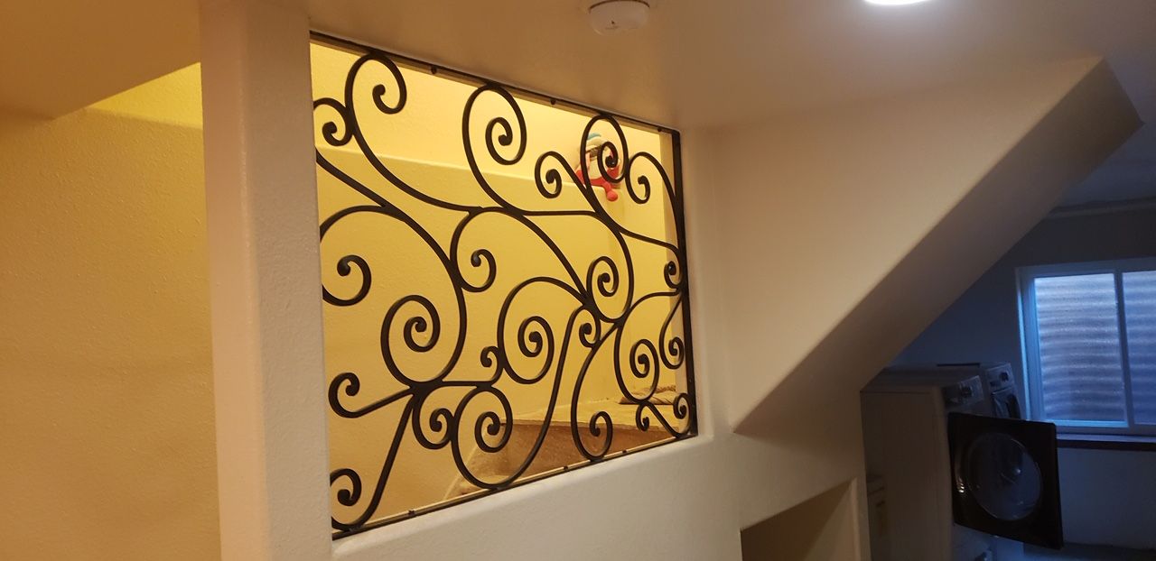 A wall with a wrought iron design on it
