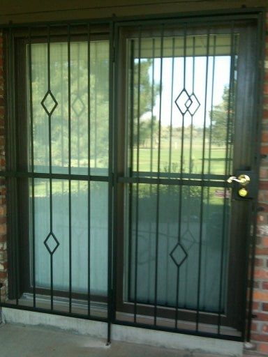 A door with a wrought iron fence around it