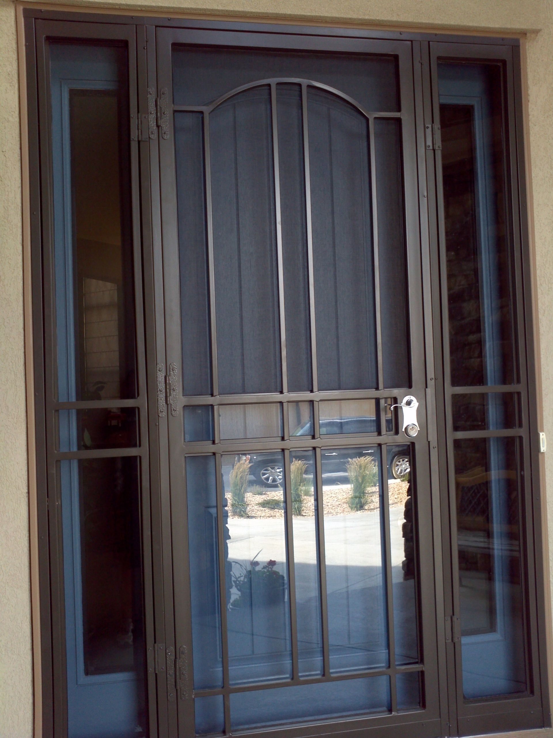 A blue door with a wrought iron fence around it