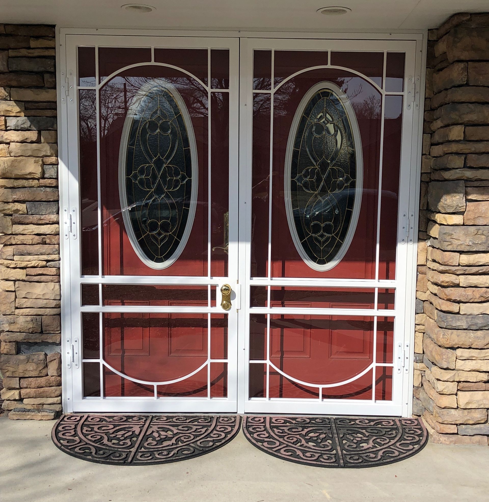 A pair of red doors with stained glass windows
