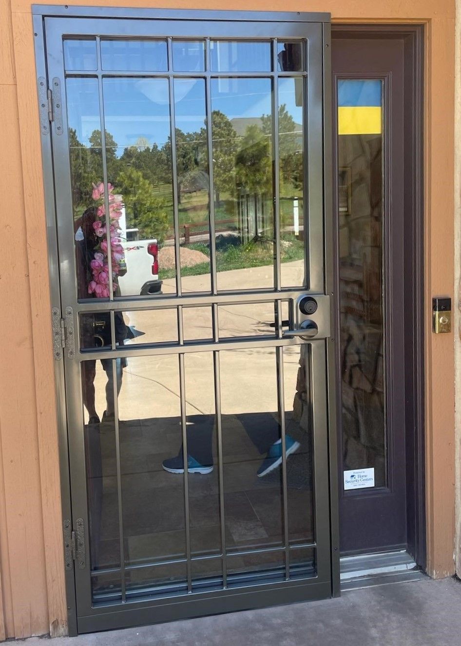 A door with a fence around it is open to a building.