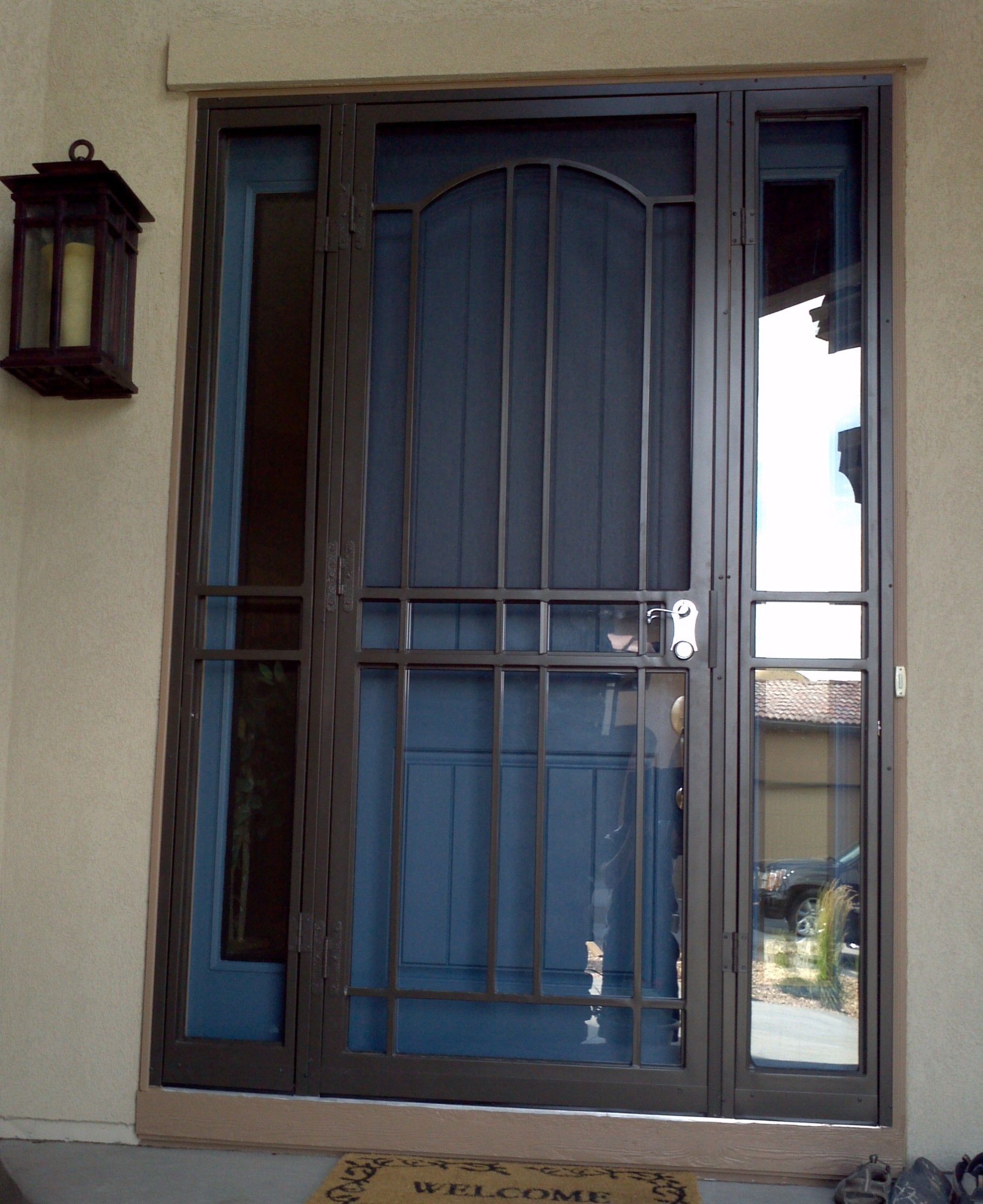 A blue door with a welcome mat in front of it