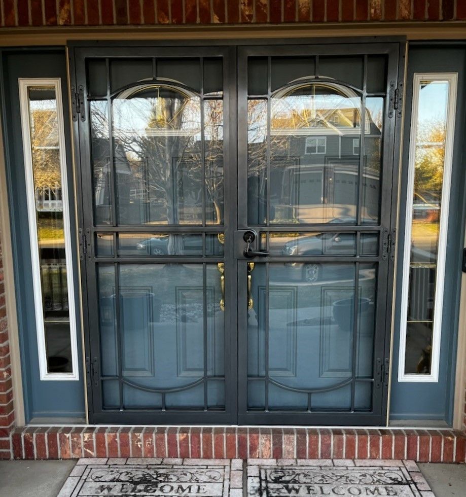 A blue door with a welcome mat in front of it